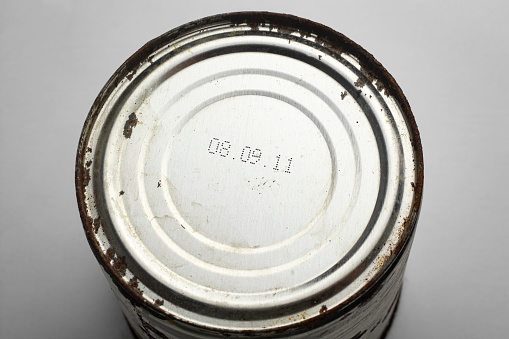 Expiration date on a rusty can of canned food.