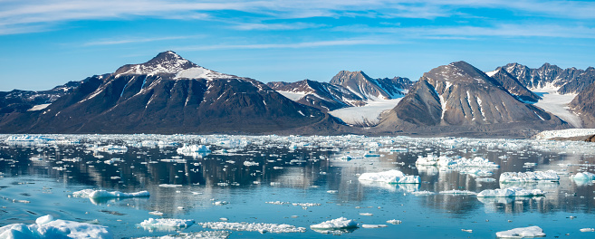 Stunning landscapes with jagged mountain peaks, glaciers and icebergs along the shores of the Liefdefjorden, Northern Spitsbergen, Svalbard, Norway