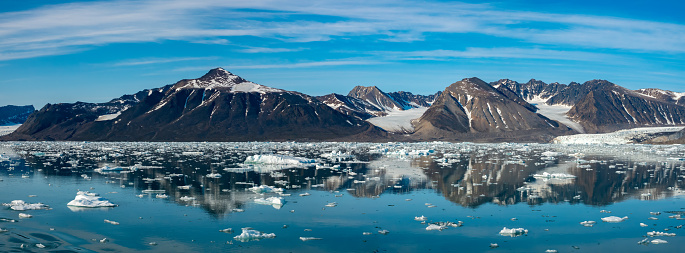 Stunning landscapes with jagged mountain peaks, glaciers and icebergs along the shores of the Liefdefjorden, Northern Spitsbergen, Svalbard, Norway