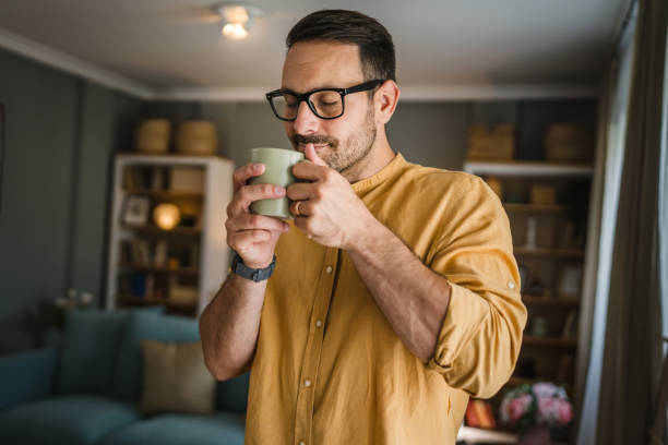 istock One young caucasian man having cup of coffee while standing at home 1674493804