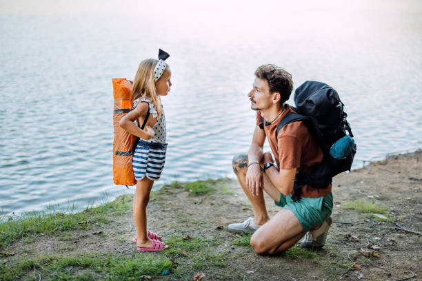 istock Father and daughter by the lake 1674494183