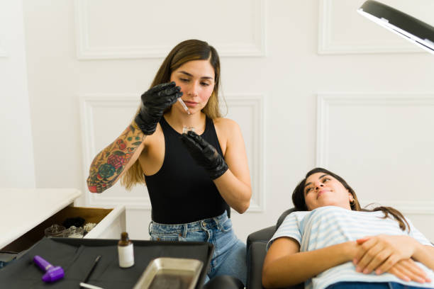 istock Mexican cosmetologist putting on oil serum after brow microblading 1674494425