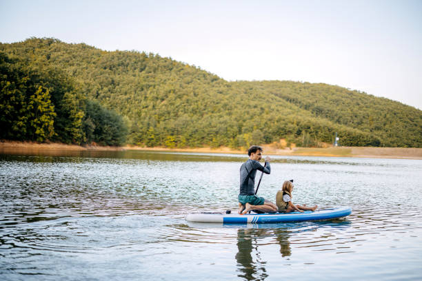 istock Father paddles with his daughter 1674495719