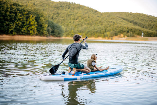 istock Father paddles with his daughter 1674496254