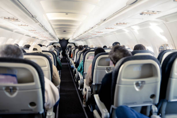 istock Aeroplane cabin with rows of seats down the aisle 1674500771