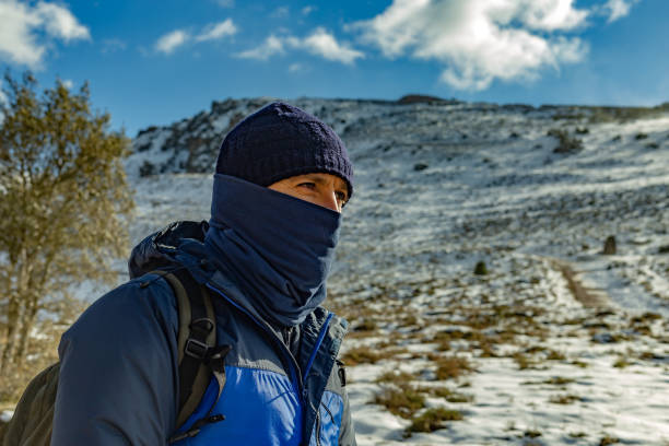 Pancorbo, Burgos, Spain, Warmly dressed hiker walking in a snowy mountain environment on freezing day.