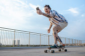Urban people. Young man on a skateboard, using phone