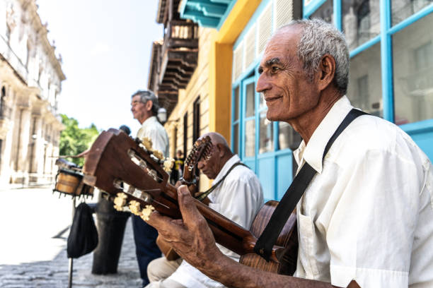 istock Senior man playing the guitar outdoors 1674541176