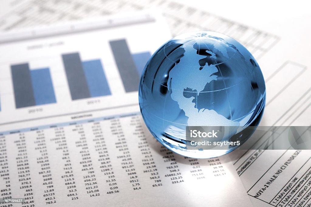 glass globe business. Global Market Glass globe with North America and business papers Globe - Navigational Equipment Stock Photo