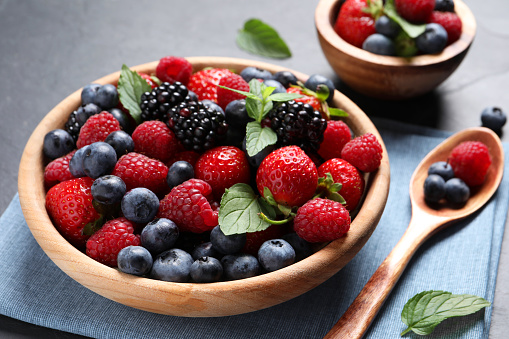 Many different fresh ripe berries on black table, closeup