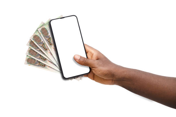 istock Black hand holding mobile phone with blank screen and United Arab emirates dirham 1674567026