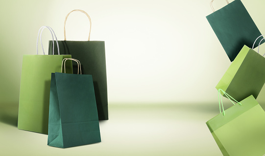 Hot sale. Colorful shopping bags on light green gradient background, space for text
