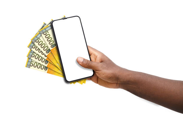 istock Black hand holding mobile phone with blank screen and 50000 South Korean won notes 1674570468