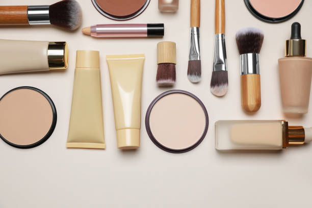 istock Face powders and other makeup products on beige background, flat lay 1674573730