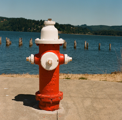 Bright red and white fire hydrant along Coos Bay