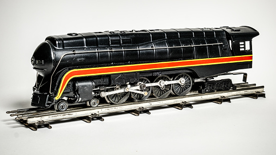 Toy of a historical steam locomotive from the 1930s on green background