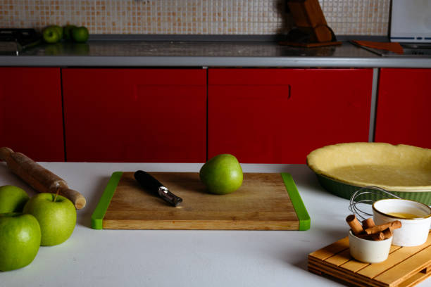 istock One green apple on a cutting board and kitchen knife on a table with ingredients for apple pie 1674589040