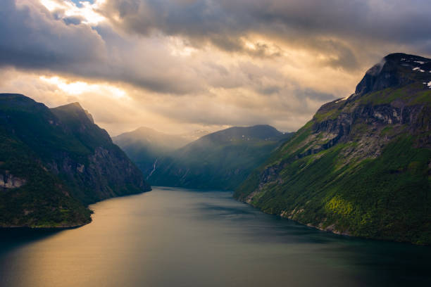 istock Dramatic sunbeam from the clouds over the Geirangerfjord,  Norway 1674599754