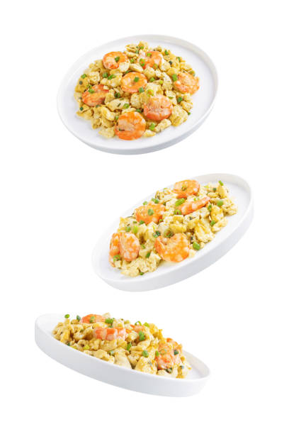 Shrimp  scrambled eggs with scallion in a plate on a white isolated background. toning