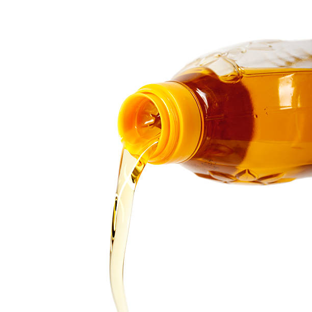 istock Pouring sunflower seed oil isolated on white background 167460326