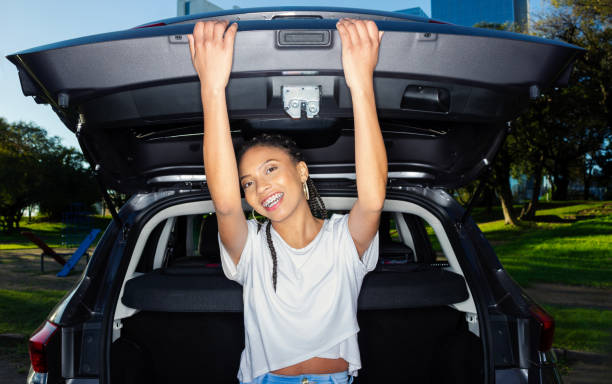 istock woman posing with her new car 1674604618
