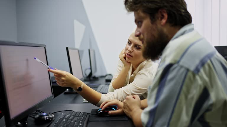 Students Helping Each Other In A Programming Class