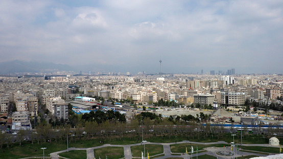 The cityscape of Tehran with the view of the Milad tower in the smog