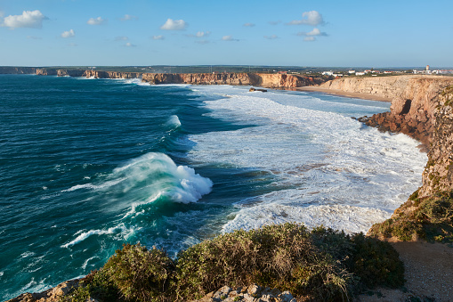Breathtaking view of the Algarve coast with huge waves from the Sagres Fortress in Portugal