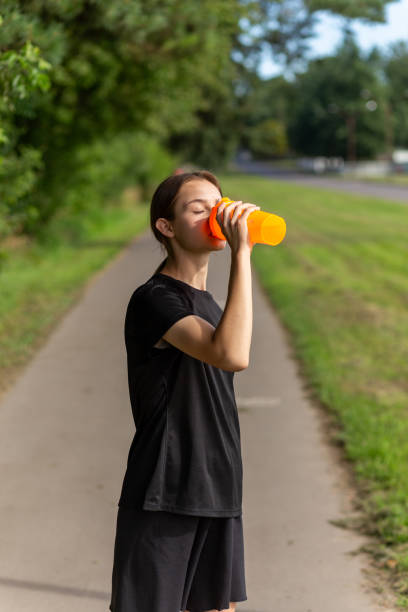 istock Fit tennage girl runner outdoors holding water bottle. 1674658092