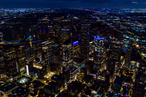 The skyline of Houston, Texas illuminated at night shortly after sunset shot via helicopter from an altitude of about 1300 feet.