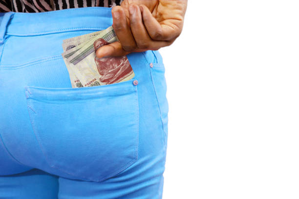 istock Black lady putting few Egyptian pound notes into her back pocket. Removing money from pocket, hold money 1674682712