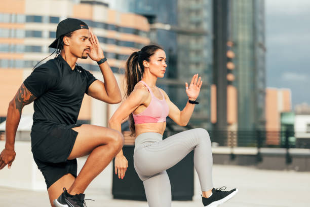 istock Muscular athletes jumping and running on the rooftop 1674783825