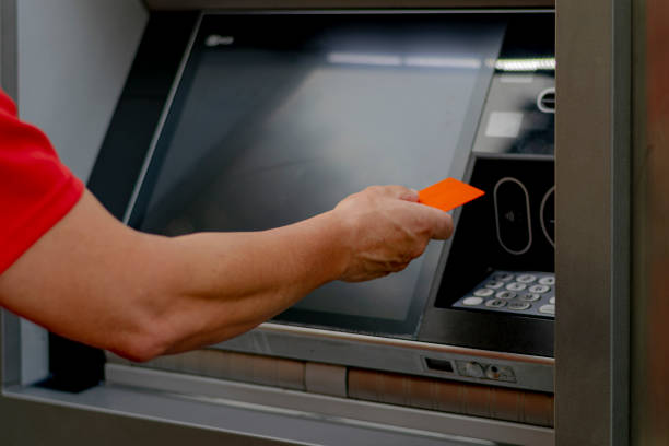 istock A man's hand operates an ATM machine in the street 1674793908