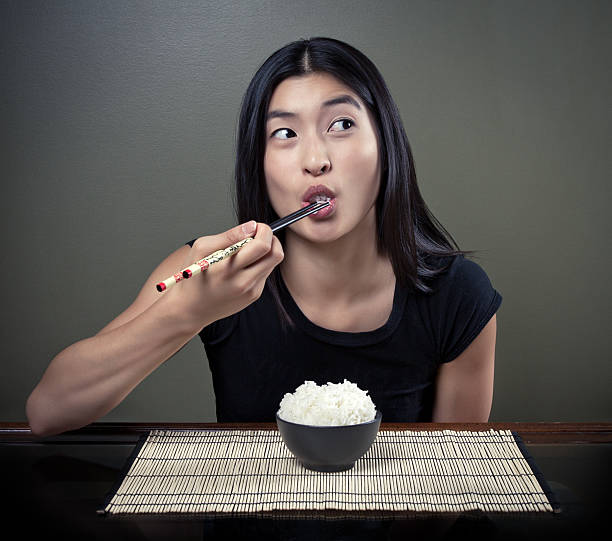 Chinese Girl Eating Rice stock photo