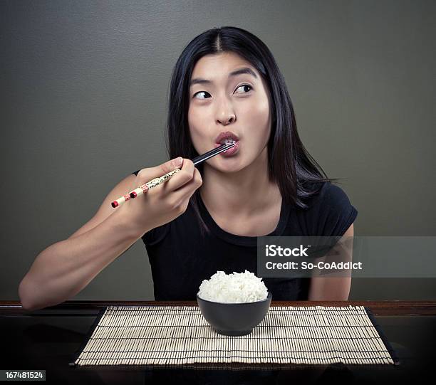 Chinese Girl Eating Rice Stock Photo - Download Image Now - Studio Shot, Eating, Asian and Indian Ethnicities