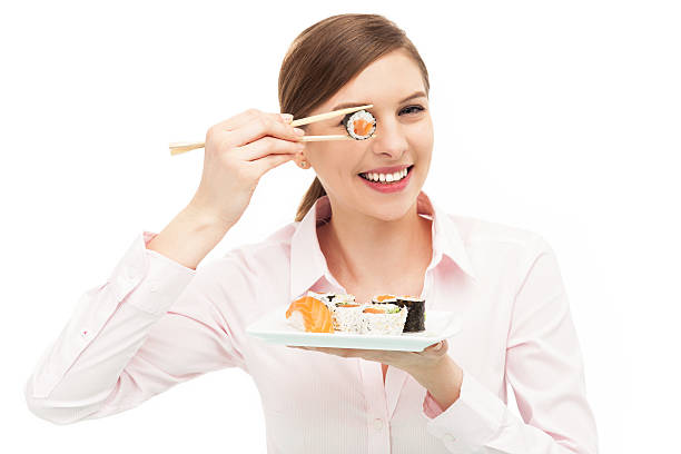 istock Beautiful woman eating sushi 167481561
