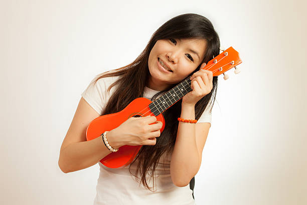 istock Aian woman enjoy her Ukulele 167482214