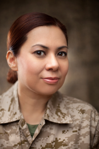 US Marine Female Soldier portrait. The model is wearing an official Marine corps Marpat uniform, helmet and body armor.