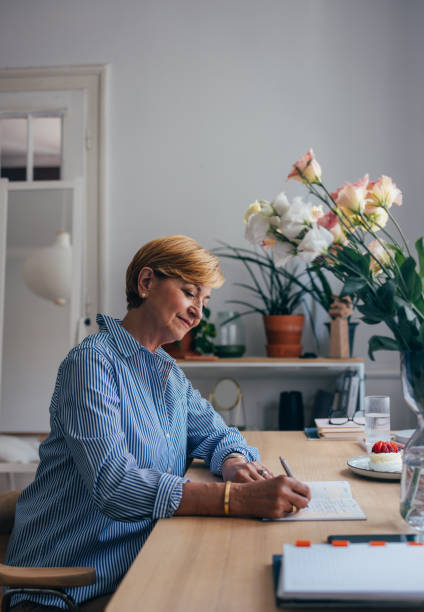istock Beautiful Senior Woman Writing Down Some Notes 1674853344