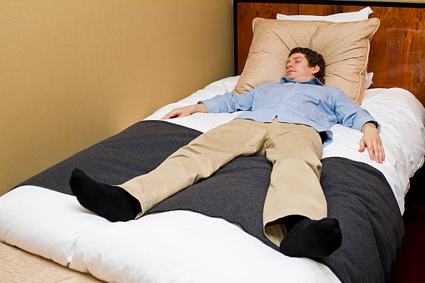 istock Man Asleep on Hotel Bed 167487060