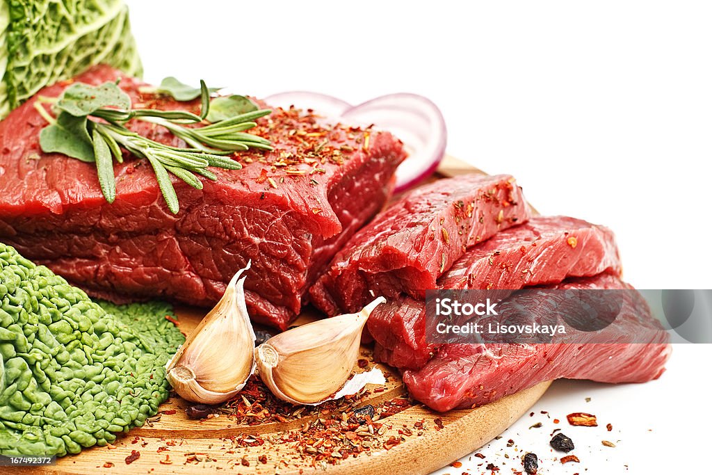 Raw fresh meat Raw fresh meat on board with condiments on white background Beef Stock Photo