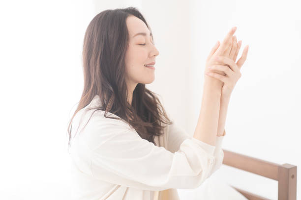 istock An Asian woman is applying hand cream on her hands. 1674934465