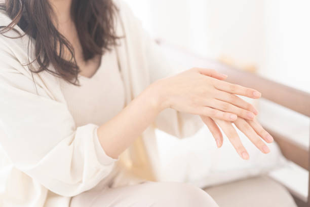 istock An Asian woman is applying hand cream on her hands. 1674934467
