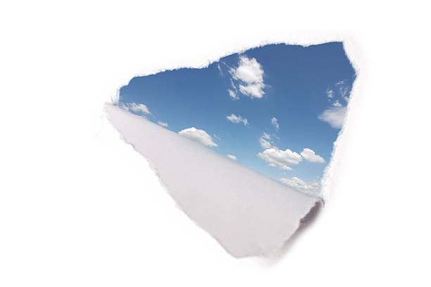 istock hole in paper with view to sky 167494764