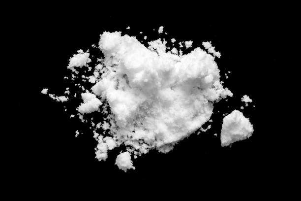 istock White snow isolated on black background close up 1674948492
