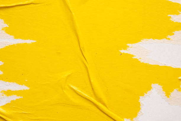 istock Old grunge ripped torn yellow paper poster surface texture background 1674950142