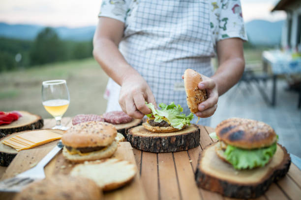 istock Assembling a homemade burger at a garden party. 1674963345