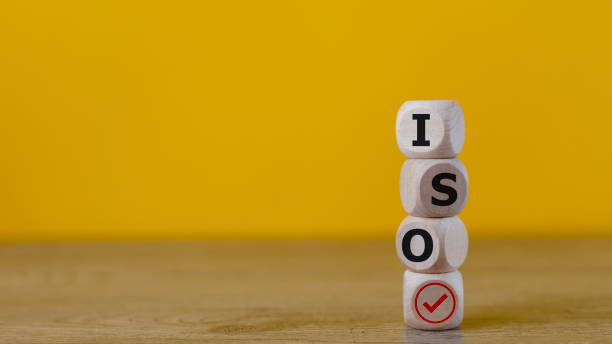 istock ISO standards verification, quality control certification approval. Cubes with the word ISO and a tick on a yellow background. 1675007178