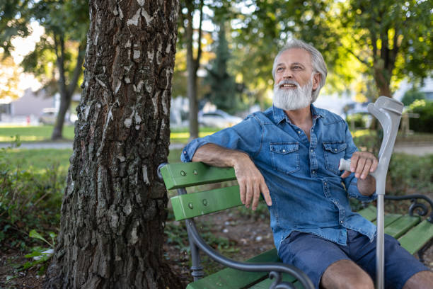 istock An elderly man with a disability and on crutches 1675054418