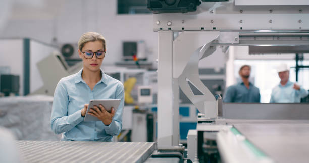 Tablet, production and engineering with woman in factory for robotics, futuristic and automation. Inspection, technology and machine with person for manufacturing, industry 4.0 and electronics